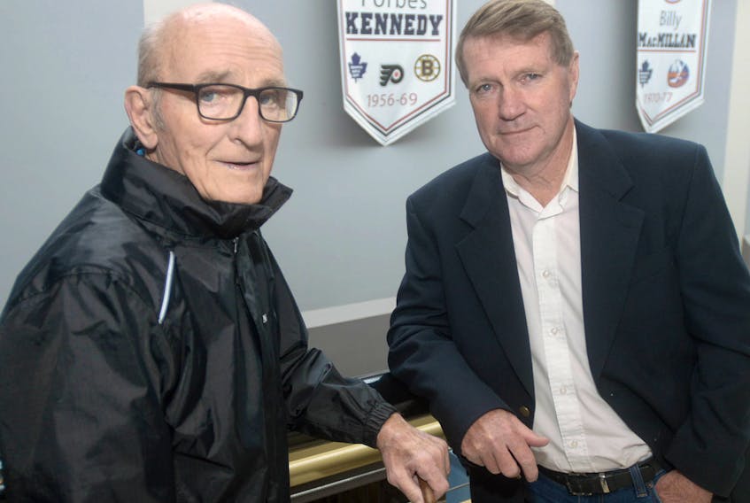 Forbes Kennedy, left, and Gary MacDougall meet up at Eastlink Centre prior to the launch of MacDougall’s book on the former NHLer, which will be titled “Forbie.” Behind the two is a banner that hangs in the centre’s lobby that recognizes Kennedy and his impact on the hockey world.