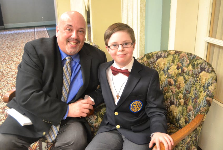 2018 Easter Seals Ambassador Brayden White is congratulated by his father, Melvin Ford, during the campaign kickoff at the Charlottetown Hotel on Monday.
