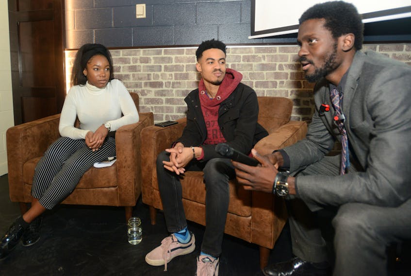 Moderator Luke Ignace, from right, chats with panelists Isaiah Sealy and Nkine Bissong following a discussion at the Fox and Crow Tuesday as part of Black History Month. The event saw panelists discuss ways to make P.E.I.’s black community more represented in the province.