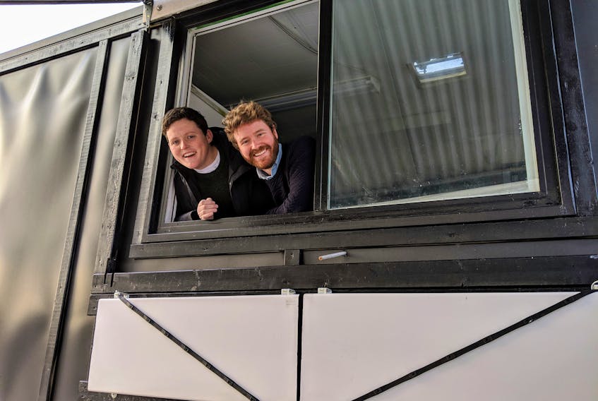 Mikey Wasnidge and Jesse Clausheide poke their heads out of the window of their food truck. They bought the trailer on a whim and plan to open their business, Nimrods’, on March 29.