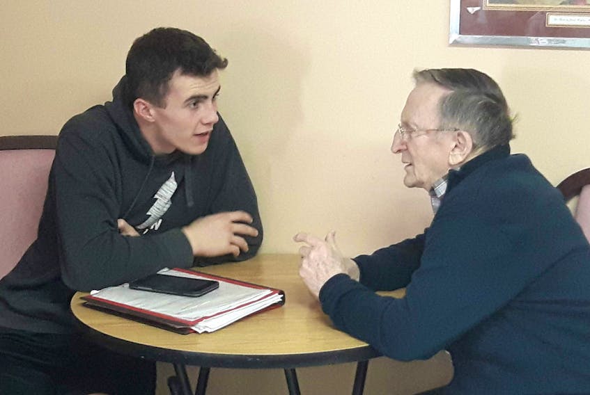 Grade 11 student Hansen Younker speaks with Whisperwood Villa resident Harold MacDonald as part of a book project between the home and Immanuel Christian School.