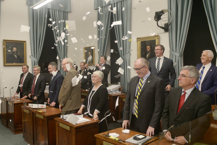 MLAs throw papers in the air following the end to the spring sitting of legislature Tuesday night.