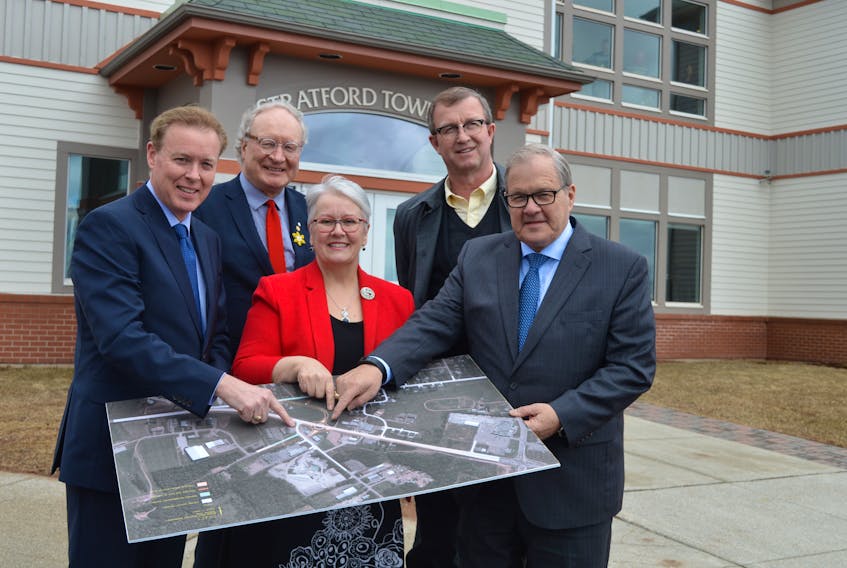 From left, Stratford Mayor David Dunphy; Premier Wade MacLauchlan; Minister of Transportation, Infrastructure and Energy Paula Biggar; Vernon River-Stratford MLA Alan McIsaac; and Minister of Agriculture and Agri-Food Lawrence MacAulay point to the place on a map that where a roundabout will be constructed in Stratford this year.