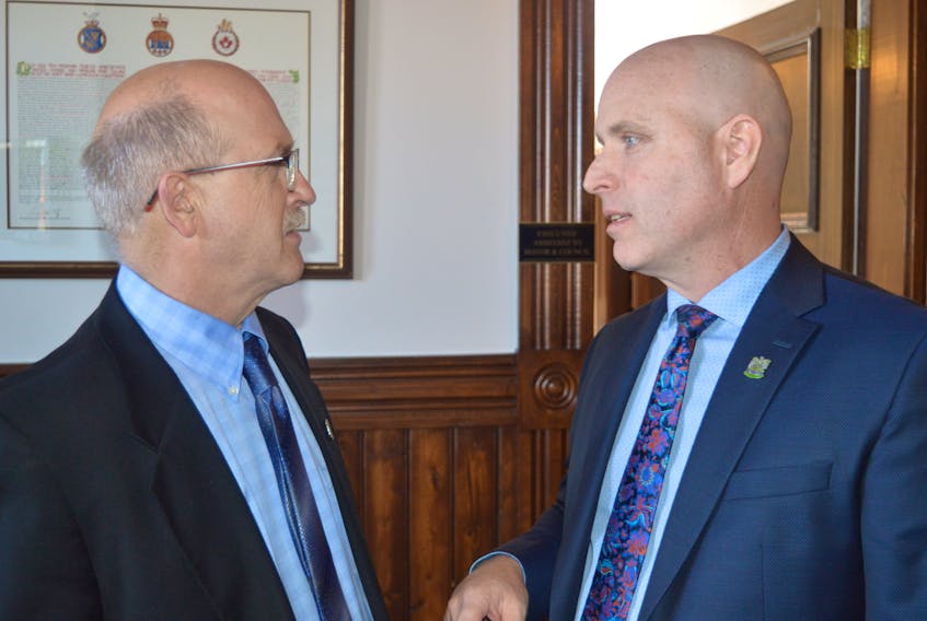 Coun. Greg Rivard, right, chairman of the planning committee, talks to Coun. Terry Bernard, chairman of the finance committee, prior to city council’s regular public monthly meeting on Monday. Council has begun the process of development a bylaw that will regulate short-term rentals in the capital city.