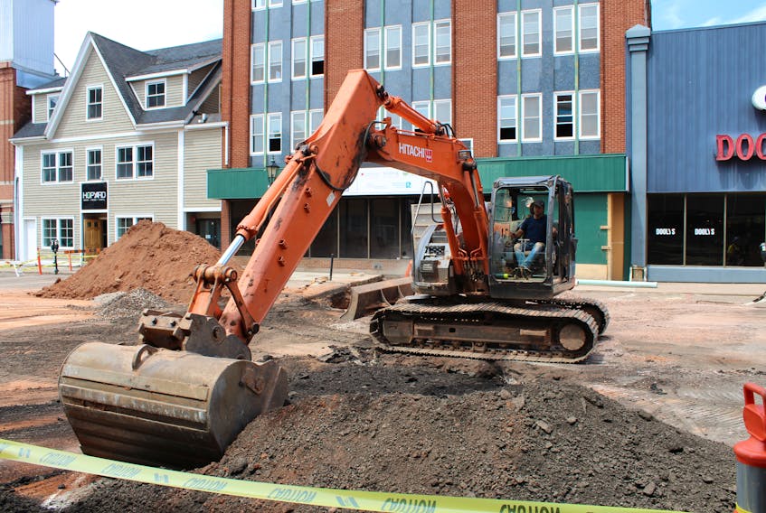 A piece of heavy machinery moves a pile of dirt outside the former Myron's nightclub on Kent Street in Charlottetown Thursday as part of water and sewer service installation work. Dyne Holdings Ltd. will manage the new Arts Hotel at the former nightclub site.