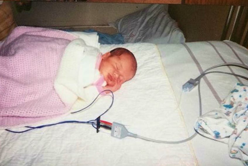 Emma Taylor, 11 days old, is pictured at the Queen Elizabeth Hospital after experiencing Sudden Infant Death Syndrome. The family is now trying to track down the people who helped to save Taylor's life.