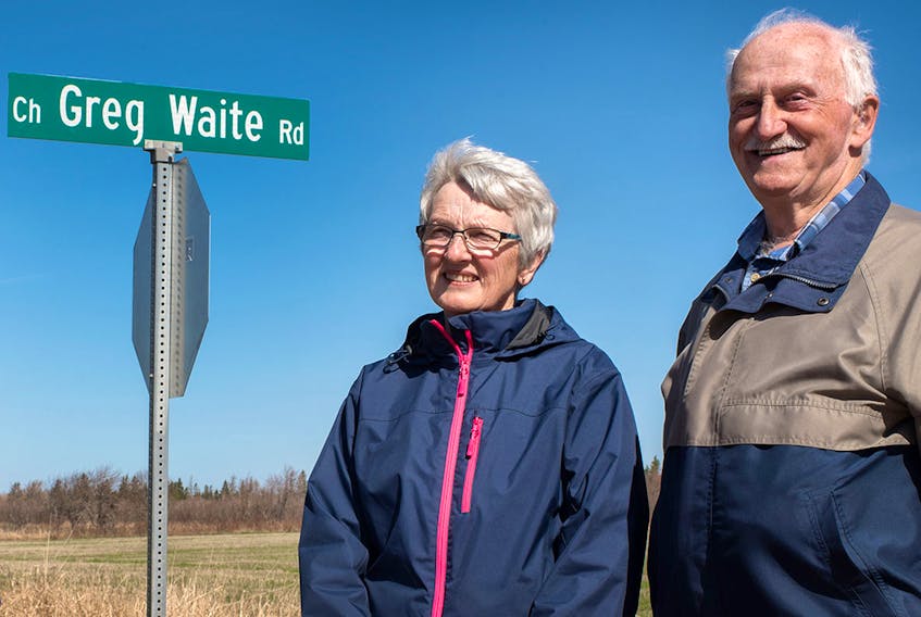 Miriam Waite, wife of the late Greg Waite, and David Linkletter, chair of the Linkletter community council, take part in a ceremony at the site of the new road named in Greg Waite's honour.