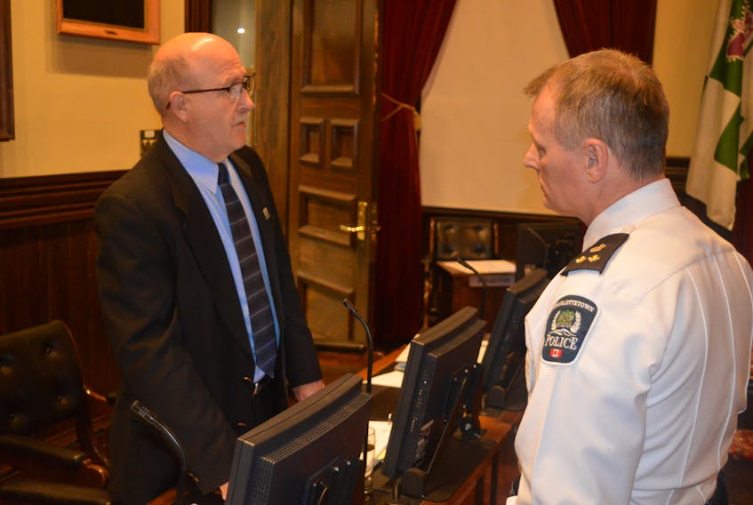 Coun. Terry Bernard, left, chairman of Charlottetown’s public works committee, chats with Deputy Police Chief Brad MacConnell prior to Tuesday’s regular public monthly meeting of council. Bernard asked council to allow Chapman Bros Snow Removal to stay on Ralden Avenue for one more winter.