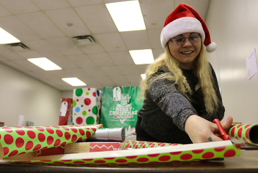 There were dozens of busy “Santas” sorting and wrapping gifts on Thursday to be given to nearly 700 Prince County seniors through the “Be a Santa to a Senior” program. This year Home Instead Senior Care contacted various organizations across the Island looking for names of seniors who may need an extra bit of Christmas cheer with a small gift from a stranger. Names were doled out as well as a small list of items each individual wanted on gift tags that members of the public could pick up. With the initiative in its final phase, students from the resident care worker program with Marguerite Connolly Training and Consulting are dropping off the gifts. “It’s so heartwarming to see the looks on the seniors’ faces at just the simplest gift. It was so humbling. It’s an experience I wish everyone could feel,” said Jalessa Perry, shown wrapping one of the gifts.