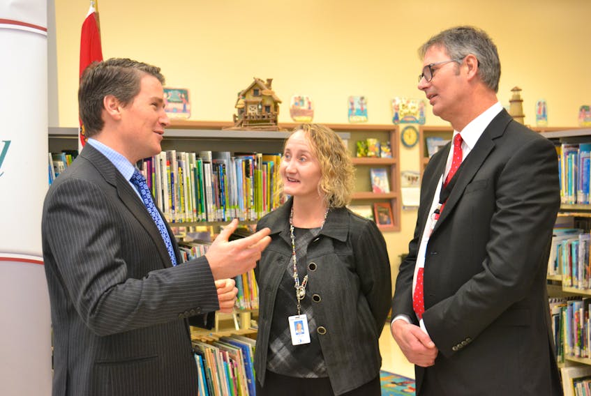 Education Minister Jordan Brown, from left, Marilyn MacLean, principal at West Royalty Elementary School, and Parker Grimmer, director of the Public Schools Branch, discuss the province’s plans to tackle the waiting list for psychological assessments in P.E.I. There are currently 435 students on that waiting list, one government hopes to wipe clean by 2020.