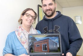 Sherri Spatuk and Mark Mahar, of M4G Alternative Housing, show a picture of their 382 square foot tiny home following a presentation at Georgetown Genevieve Soloman Memorial Library on Saturday. The couple have seen a lot of interest in the home since its completion, with some believing similar dwellings could help solve P.E.I.’s affordable housing shortage.