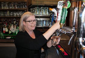 Jillian Campbell, a server at the recently sold Olde Dublin Pub in Charlottetown, pours a beer Friday.