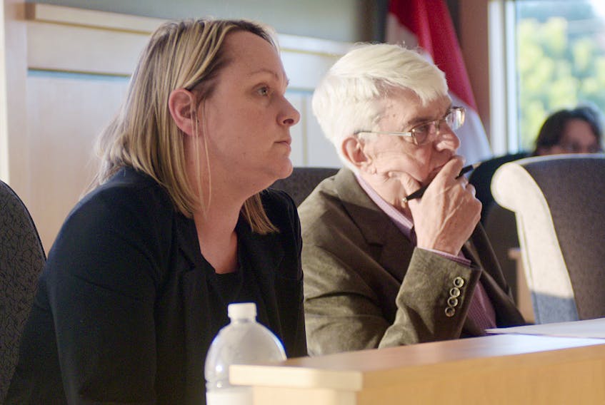 Cornwall Coun. Jill MacIsaac, left, and Coun. Peter Meggs listen to a report during Wednesday’s monthly meeting. Council voted to give preliminary approval to an amended proposal of the Harvest Hills subdivision.