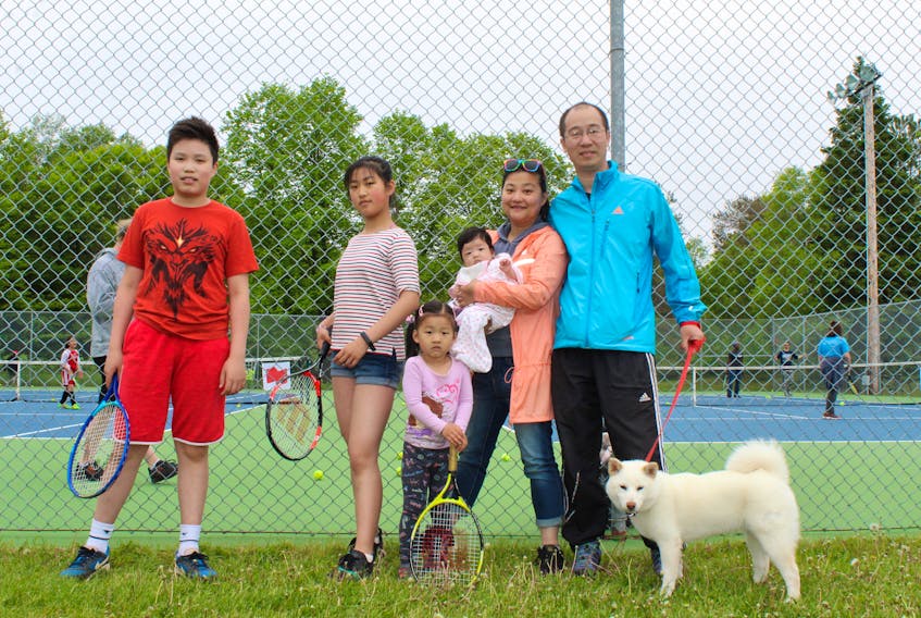 The Zhang family celebrated their first Father’s Day weekend on P.E.I. during a tennis event hosted by the P.E.I. Association for Newcomers on Saturday in Victoria Park. Shown from left are: family friend Raphael Tang, Karry, 11, Reena, 4, infant Aimee, mom Sophy Huang and father Andrew Zhang. - Katherine Hunt