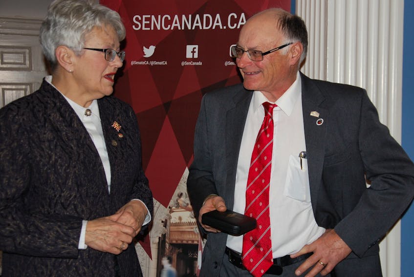 Daniel MacKinnon, owner/operator of Sandrae Farms in Brooklyn, P.E.I., chats with Lt.-Gov. Antoinette Perry after receiving the Senate Canada 150 medal Friday at Government House. (JIM DAY/THE GUARDIAN)