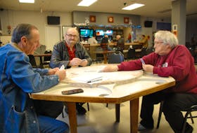 Long-time Charlottetown Legion members Wayne Acorn, left, and Catherine Kerr, enjoy a game of rummy with Brian Walsh, a non-member but a regular at the branch on Pownal Street. The branches are billed as a comfortable place for socializing but most importantly as a strong supporter of veterans.