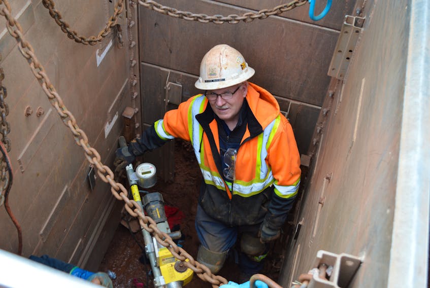 Blaine Parkman, foreman with the City of Charlottetown’s Water and Sewer Utility, works nine feet below the pavement level on Queen Street Thursday to repair a sprinkler line. Parkman thinks they’ll have to shut the water off for a two-block radius around 10 p.m. tonight to complete repairs.