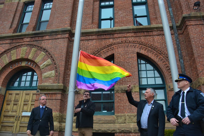 Charlottetown Mayor Philip Brown, left, joined Daniel Boudreau, chairperson of Pflag Canada P.E.I., Coun. Kevin Ramsay and Deputy Chief Sean Coombs in raising the pride flag at City Hall on Friday. The flag was raised in the midst of a controversy surrounding the town of Alberton’s refusal to fly a Pride flag.
