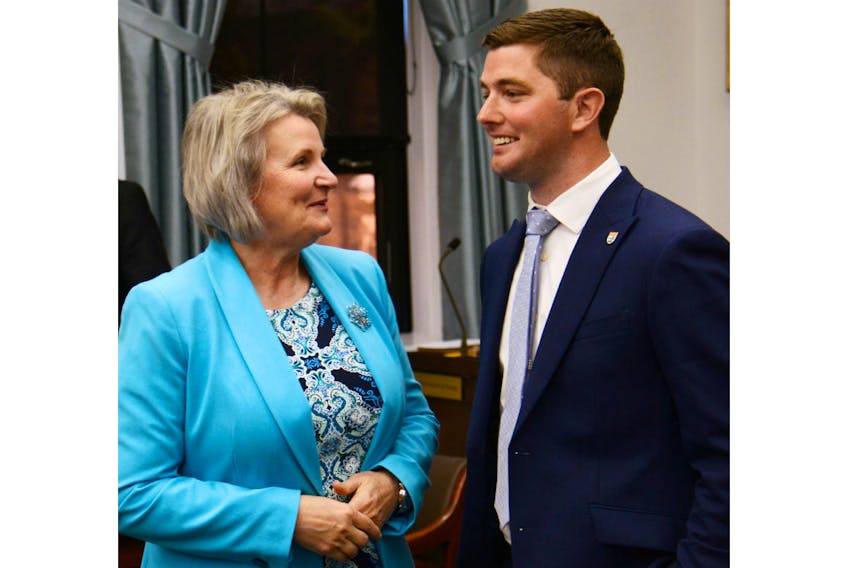 PC MLAs Darlene Compton and Cory Deagle talk before the first question period of the new legislative session June 18.