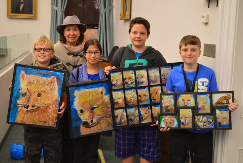 The Grade 5-6 class from Montague Consolidated School made a presentation to the Standing Committee on Education and Economic Development on Wednesday, asking that the red fox become the provincial animal. Part of the presentation involved showing the committee paintings of red foxes by local artist David Trimble of the red fox. Pictured from left, are Connor Cheverie, class teacher Edwena Arbuckle, Meadow Papp, Isaiah Williams and Alex Beck. Dave Stewart/The Guardian