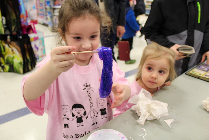 Five-year-old Charlottetown resident Brooklyn Stretch, from left, and her two-year-old sister Brielle Pawlowska make some slime while donning their new shirts given out by Toys ‘R’ Us Canada to support the anti-bullying Pink Shirt Day campaign. Pink Shirt Day educates and inspires Canadians to take action against violence and bullying. Toys ‘R’ Us Canada gave shirts reading “Be a Buddy, Not a Bully” to its first 100 customers after 11 a.m. on Saturday.