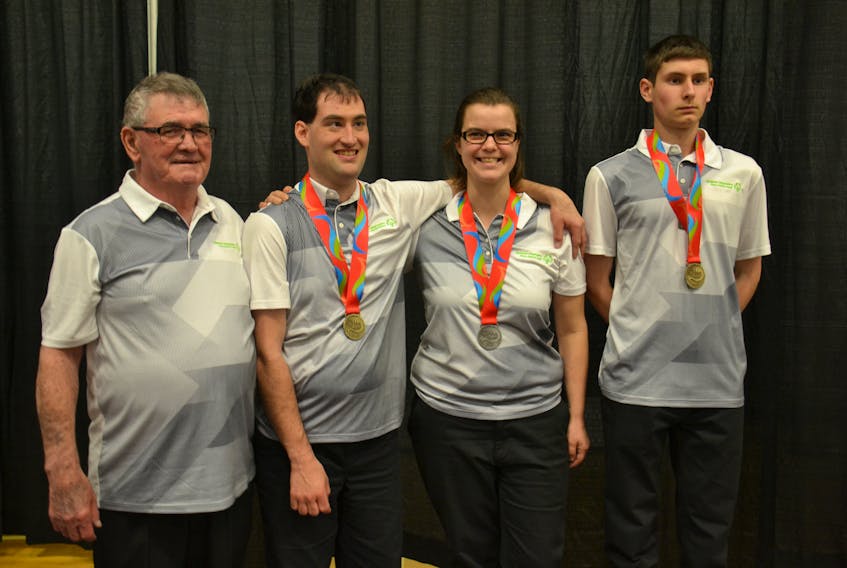 Ricky Burns, coach of the P.E.I. Special Olympic 5-pin bowling team, poses with the three Island medal winners from the 2018 5-Pin Bowling Championships at an awards ceremony in Charlottetown on Saturday, including Kaitlynn MacKinnon of Charlottetown, Degan Hackett of West Devon and Jonathan Watts of Cove Head.