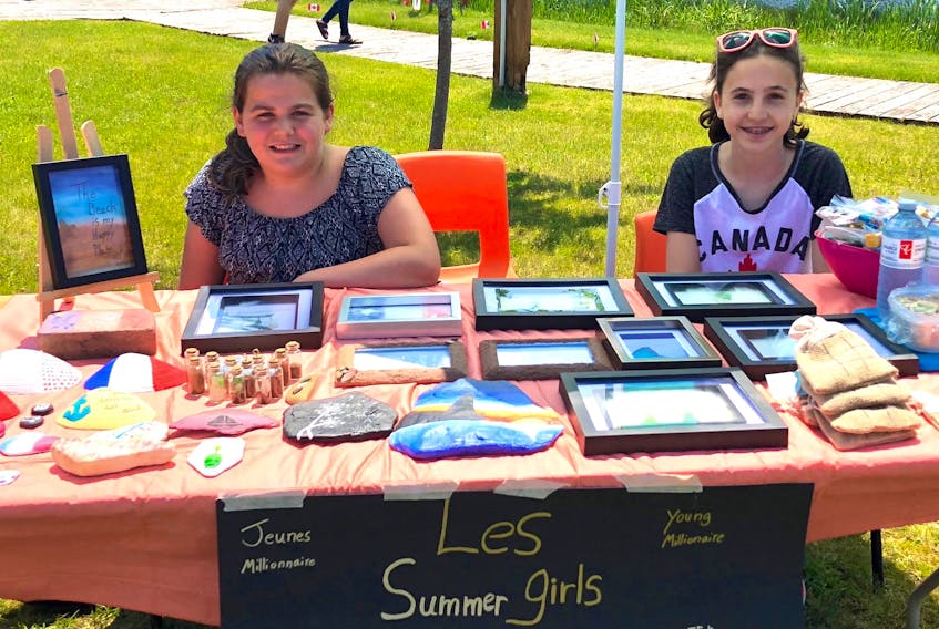 Through their business, Summer Girls, Taylor Hardy, left, and Lydia Arsenault sell treat bags and frames decorated with sea glass, shells and painted rocks. They learned their entrepreneurial skills through the Jeunes millionnaires/Young Millionaires Program.