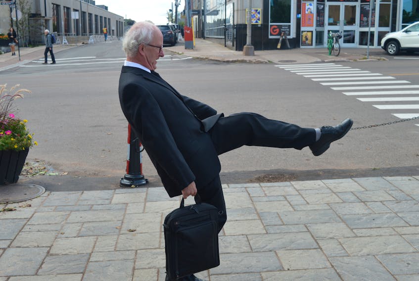 Mark Sandiford, executive director of CreativeP.E.I., does his best impression of John Cleese of Monty Python fame on Charlottetown’s new silly walk crosswalk, located parallel to Queen Street across Richmond Street at Victoria Row. The idea came from a woman on the city’s arts advisory board.