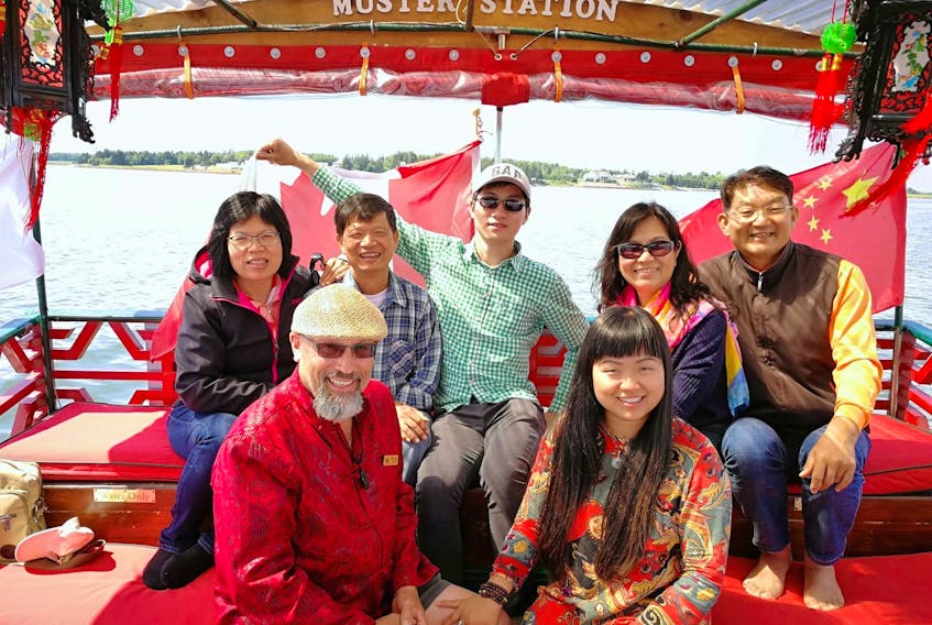 Monte Gisborne, front left and his wife, Luo Dan Ni (Daniela), pose with a group of Chinese tourists who took a ride last year aboard the couple’s Chinese junk boat that sails from Peakes Quay Marina in Charlottetown. China is a growing tourism market for Canada.