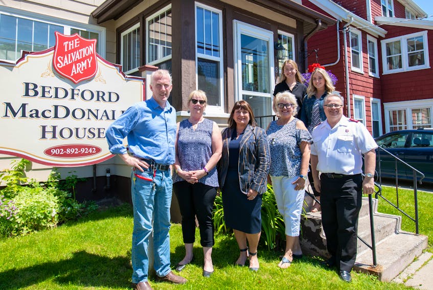 UPEI nursing students take the opportunity to put skills to use with a partnership at Bedford MacDonald House. Mike Redmond, left, Janis MacLellan-Peters, Jo-Ann MacDonald, Kathy Walsh, and Major Dan Roode stand on teh grass, while Jennifer Balderston, left, and Lauren Murphy are on the steps.