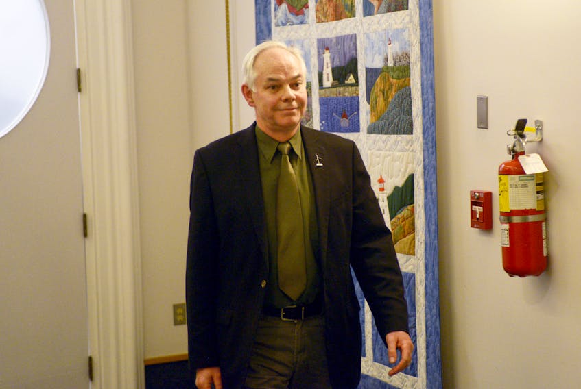 Green leader Peter Bevan-Baker leaves the P.E.I. legislature after being escorted out by the sergeant at arms Wednesday, Dec. 20, 2017.