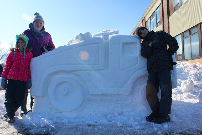 The Evangeline Region Winter Carnival takes place Friday, Feb. 23 to Sunday, Feb. 25. From left, sisters and brother Montana, Chantal and Connor Arsenault put the finishing touches on a snow sculpture at a previous winter carnival.
