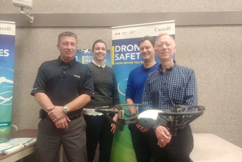 A micro drone hovers in front of Transport Canada employees Roger Smith, Jeannie Stewart-Smith, Tom Hastie and Carl Warren, who recently spoke to Islanders about new regulations coming into effect regarding the unmanned aerial vehicles.