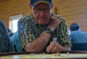 Lawson Lea and Wilfred Smith competed at the Roy Younker Memorial Tournament in St. Peter’s Bay on July 20. The doubles partners placed third at the 2018 World Crokinole Championship. Daniel Brown/The Guardian.