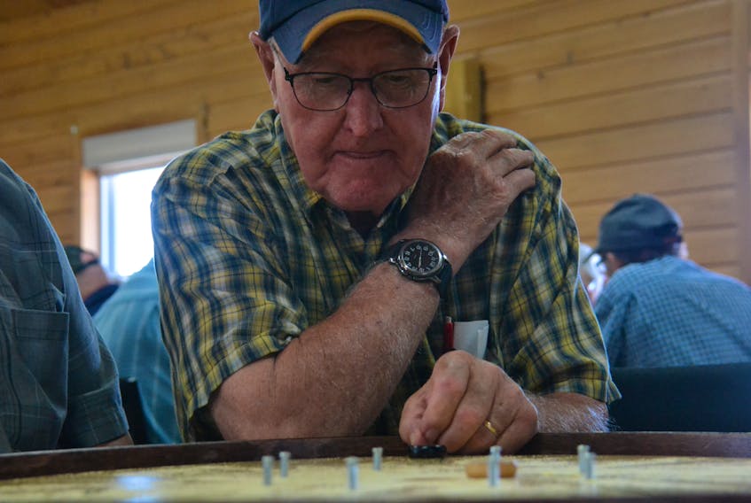 Lawson Lea and Wilfred Smith competed at the Roy Younker Memorial Tournament in St. Peter’s Bay on July 20. The doubles partners placed third at the 2018 World Crokinole Championship. Daniel Brown/The Guardian.