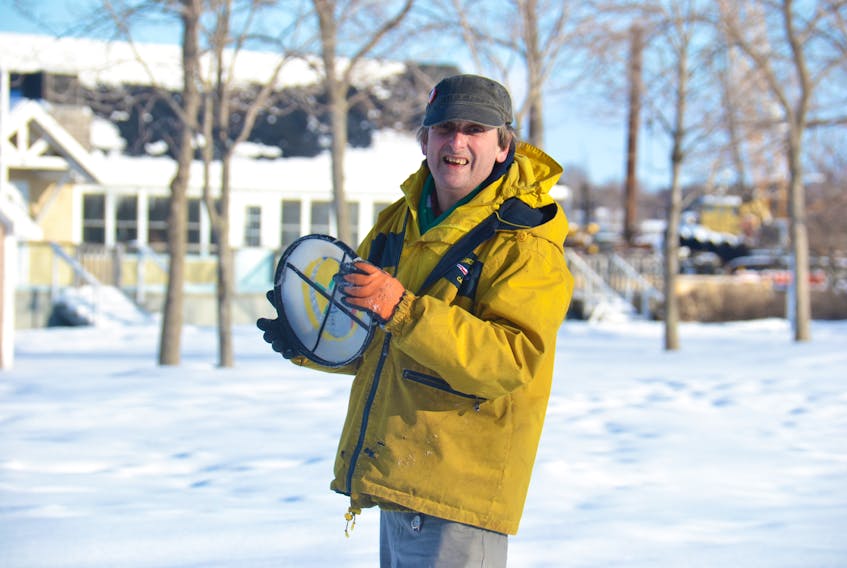 Carl Phillis throws his frisbee in the field by Founders' Hall in Charlottetown.