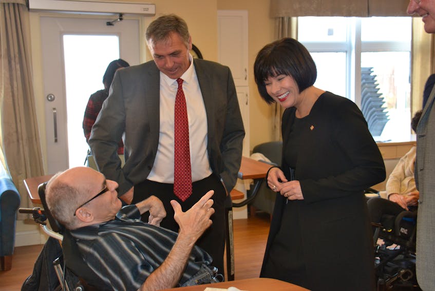 P.E.I. Health Minister Robert Mitchell and federal Health Minister Ginette Petitpas Taylor chat with Bernie Wilson, a resident of the Prince Edward Home. The health ministers signed a funding deal Friday that will see millions pour into P.E.I. from Ottawa for home care and mental health services.