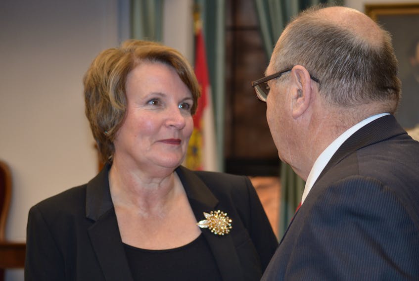 PC MLA Darlene Compton speaks with Finance Minister Allen Roach in the P.E.I. legislature. -File photo
