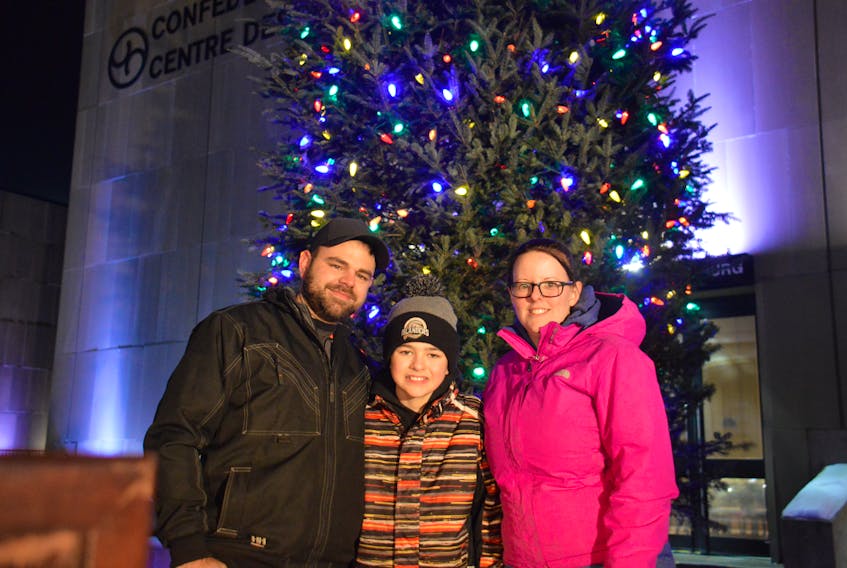 Children's Wish Foundation wish child Dakota Gallant, centre, takes in the Wintertide Holiday Festival tree lighting with his parents Brad and Stacey Gallant on Nov. 23, 2018 in Charlottetown. Dakota joined Father Christmas earlier in the night for the countdown to the tree lighting.