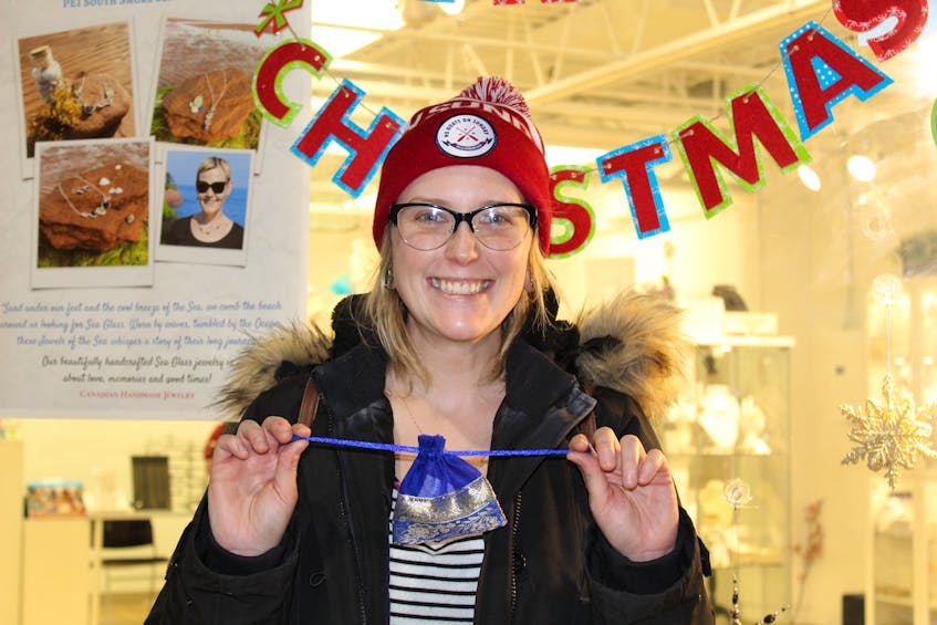 Emily Miller, of Borden-Carleton, shows one of the last-minute gifts she purchased at Confederation Court Mall on the weekend. Miller, like many Islanders, used the last weekend before Christmas to complete her shopping list.
