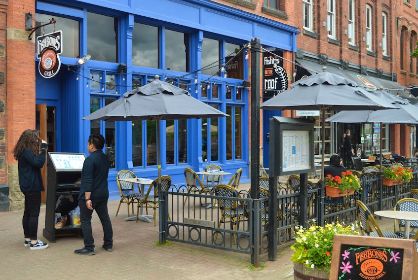 The pergola that had been erected around the outdoor deck at Fishbones Seafood House and Oyster Bar on Victoria Row in Charlottetown has been taken down following an order from the city. The restaurant didn’t have the proper permit to proceed but is now in talks with council and various city departments in an attempt to put it back up. Dave Stewart/The Guardian
