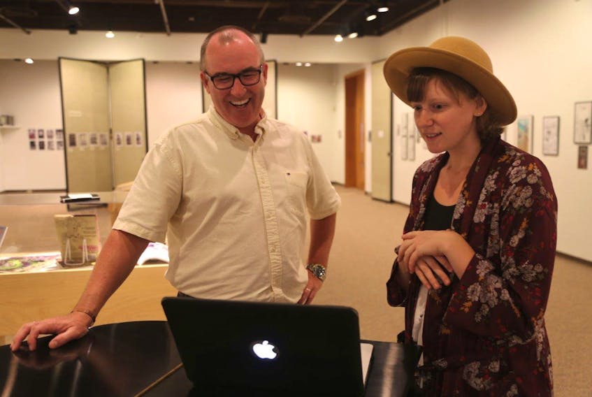 Minister of Economic Development and Tourism Chris Palmer, left, and singer/songwriter Jenni Roberge chat about some of the music videos she’s produced over the years. Roberge is one of twelve successful applicants to the provincial Arts Grants program (Submitted)