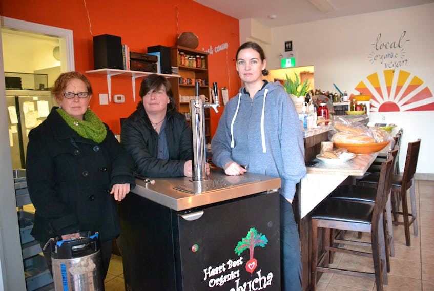 Amy Smith, left, and Verena Varga, centre, owners of Heart Beet Organics, removed their portable kombucha tap from Sarah Forrester-Wendt’s restaurant, My Plum, My Duck, Friday after a liquor inspector told them they are not allowed to sell kombucha, as it is considered an alcoholic beverage.