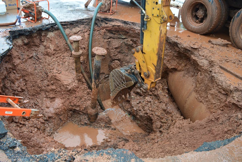 City of Charlottetown water and sewer utility crews work to repair a water main break Monday afternoon on Queen Street.