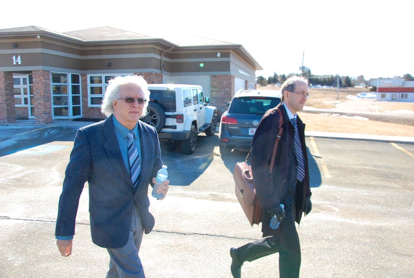 Dr. Henry Swart, left, leaves the College of Surgeons and Physicians office in Charlottetown Tuesday morning with his lawyer Tom Laughlin. Swart admitted to professional misconduct and a board of inquiry will make recommendations for disciplinary action within 30 days.