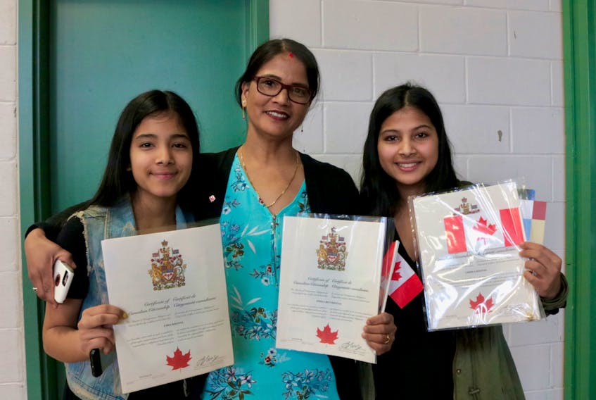 Usha Khanal, left, her mother, Omika, and her sister, Urmila, celebrate becoming Canadian citizens on Friday, 10 years after arriving in Charlottetown from Nepal.