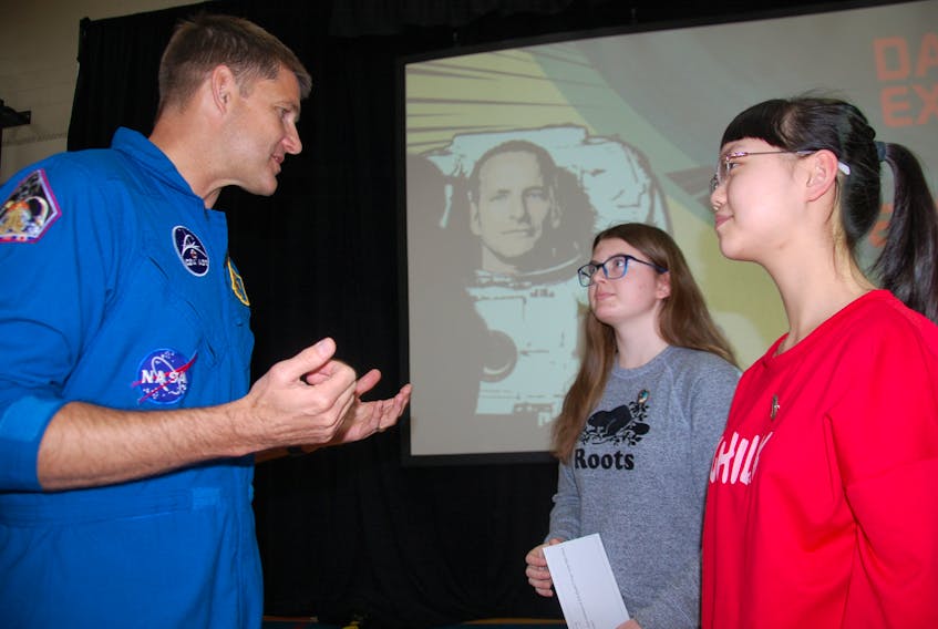 Canadian astronaut Jeremy Hansen speaks with Stonepark Intermediate students Alice Cheng, right, and Sydney Laycock Friday shortly before roughly 600 students had the opportunity to see and hear David Saint-Jacques aboard the International Space Station.