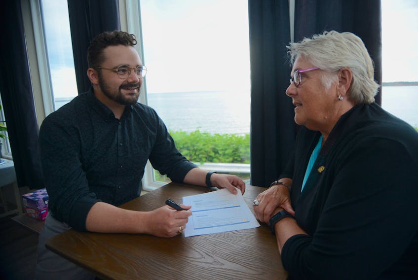 Zachary Robson of MRSB Consulting Services, left, chats with Rotary Club of Montague president Pat Campbell following a town hall on affordable housing held at Souris Legion Wednesday. The club has contracted MRSB to gather and analyze info to gain a deeper understanding of housing issues in eastern P.E.I.