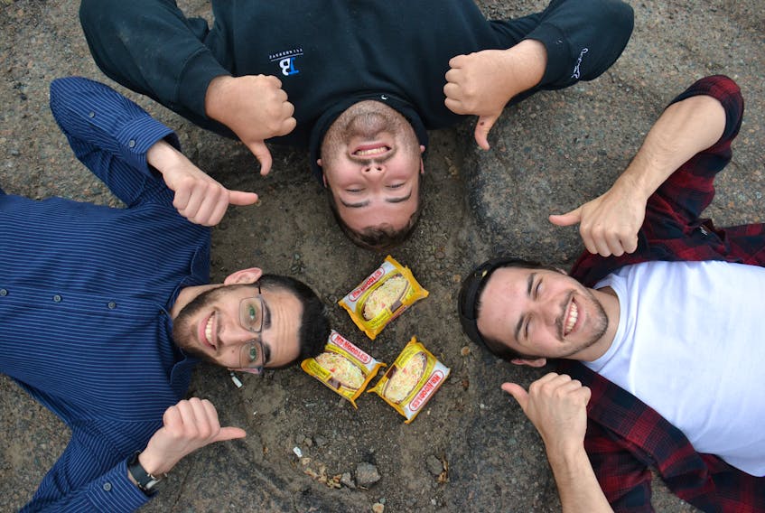 Clockwise from left, Hani Mayaleh, Jaryd Burt and Jeremie Willis surround a Charlottetown pothole with their solution to fix it – ramen noodles. Their YouTube channel, Island Boyz, started in 2017 and they’ve amassed about 10,000 followers across their various accounts.