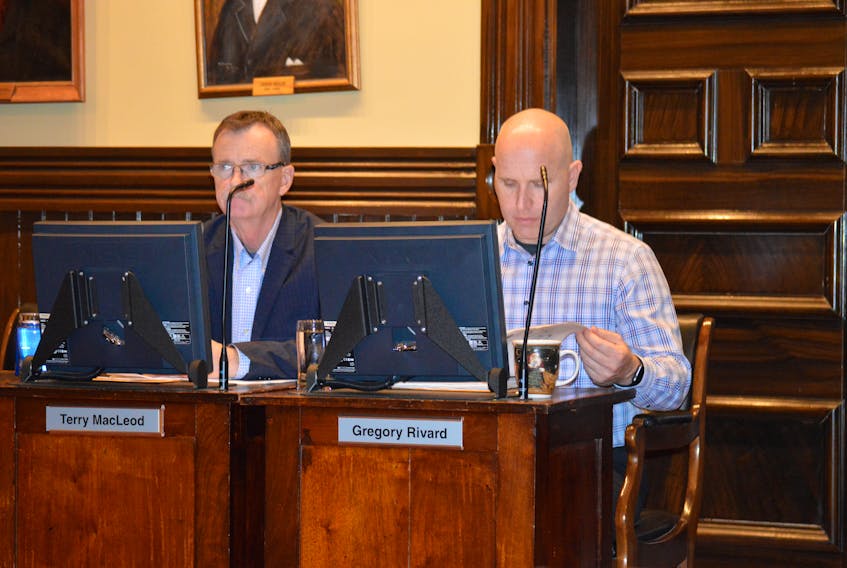 Charlottetown city council gave third and final reading to developer Tim Bank’s proposed apartment building on Richmond Street Monday night, voting 4-1 in favour of giving Banks the green light. Coun. Greg Rivard, right, chairman of the planning committee, said Banks will still have to go through the design process with the planning department. Also pictured is Coun. Terry MacLeod. (Dave Stewart/The Guardian)
)